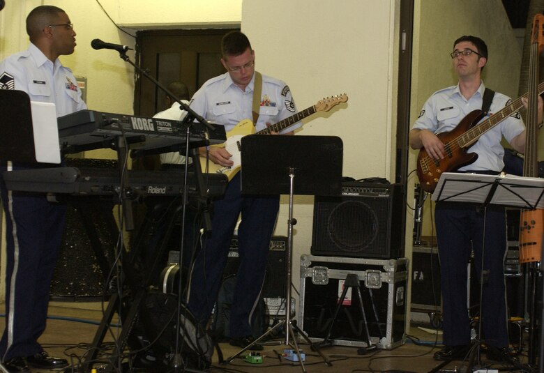 HAGATNA, Guam - Master Sgt. Craig Stevens, on the keyboard, Tech. Sgt. Toby McWilliams, guitarist, and Senior Airman Nate Bersee, base guitarist, with the U.S. Air Force Band of the Pacific's Alaskan Express perform at Chamorro Village in Hagatna, Guam. The band visited the island in conjunction with Guam's Air Force Week.  Chamorro Village was one of many locations the band performed at from Sept. 4 to 8.  (Photo by Tech. Sgt. Brian Bahret/ 36th Wing Public Affairs)     