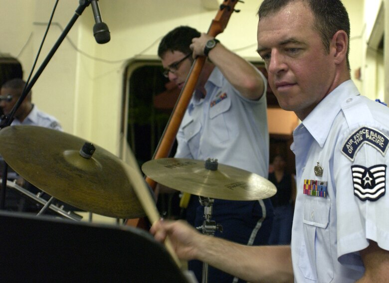 HAGATNA, Guam - Tech. Sgt. Preston Keating, drummer, and Senior Airman Nate Bersee, base guitarist, entertain an audience of hundreds at Chamorro Village, a cultural center on Guam.  Sergeant Keating and Airman Bersee are both with the U.S. Air Force Band of the Pacific's Alaskan Express.  The band visited Guam to support Guam's Air Force Week activities from Sept. 4 to 9.   (Photo by Tech. Sgt. Brian Bahret/ 36th Wing Public Affairs)