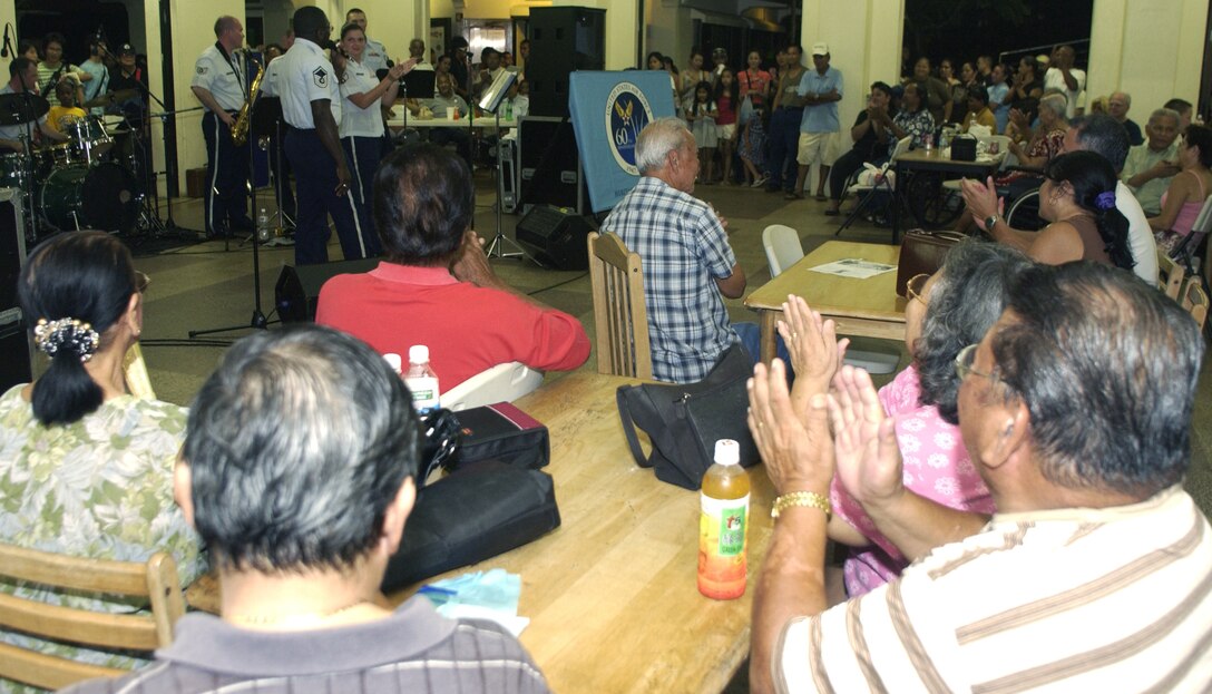 HAGATNA, Guam - Guests applaud after the U.S. Air Force Band of the Pacific's Alaskan Express completes a set at Chamorro Village in Hagatna, Guam.  The band visited the island in conjunction with Guam's Air Force Week.  Chamorro Village was one of many locations the band performed at from Sept. 4 to 8.  (Photo by Tech. Sgt. Brian Bahret/ 36th Wing Public Affairs)