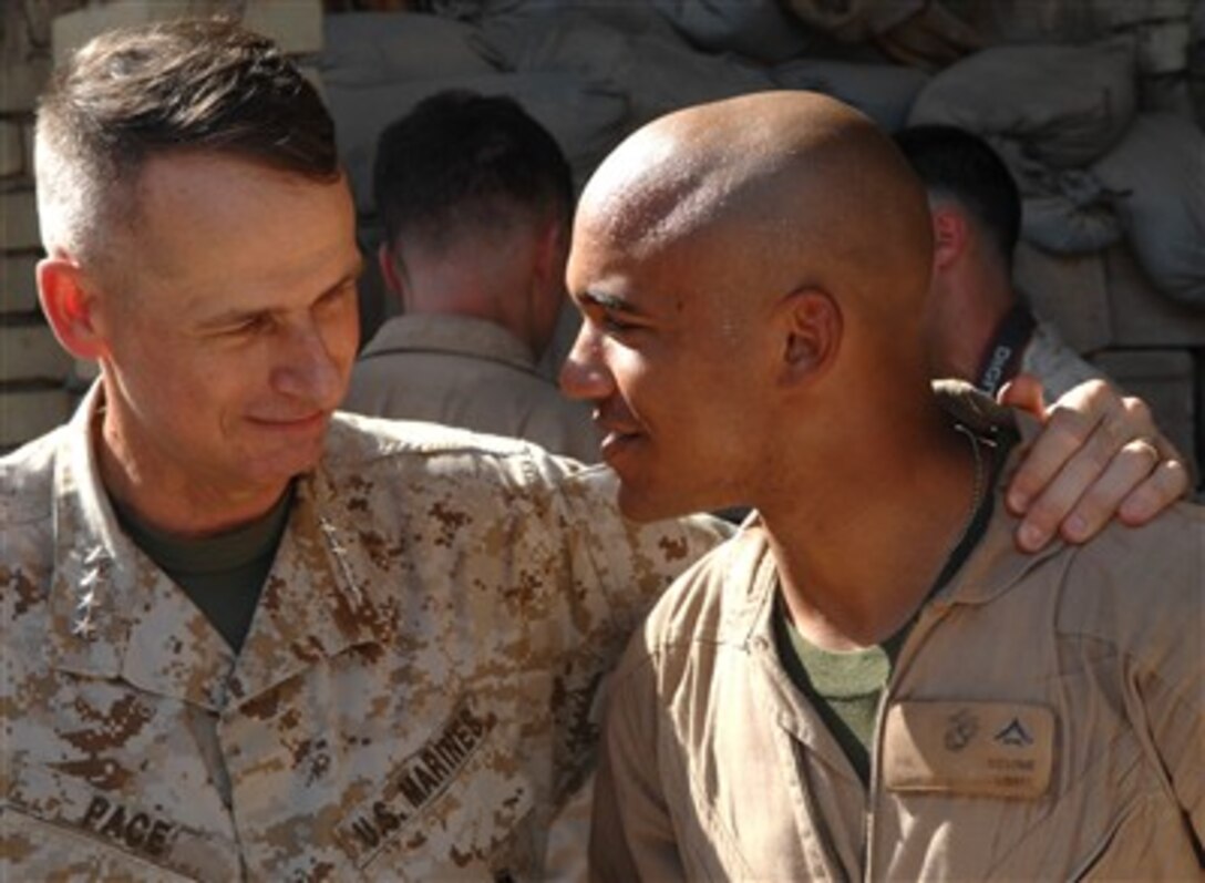 Chairman of the Joint Chiefs of Staff Gen. Peter Pace (right), U.S. Marine Corps, talks with fellow Marine Lance Cpl. Devine in Fallujah, Iraq, on Sept. 4, 2007.  Pace is visiting the troops in Fallujah and other areas of Iraq.  
