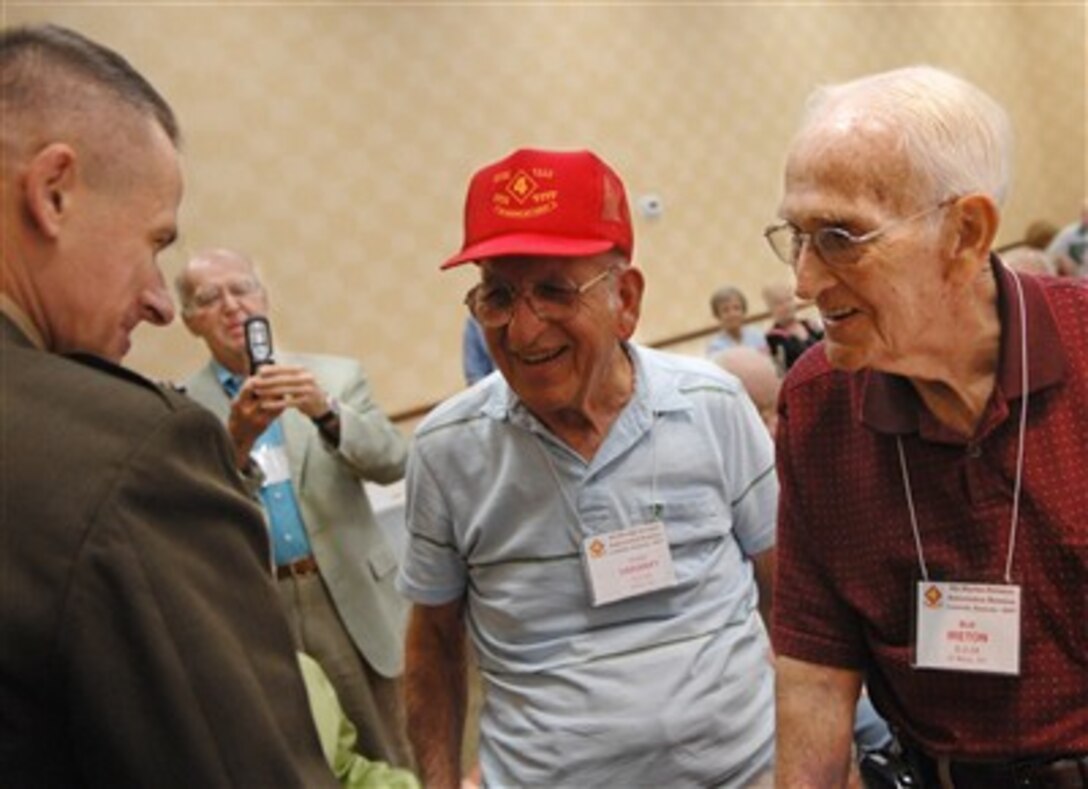 Chairman of the Joint Chiefs of Staff Gen. Peter Pace (right), U.S. Marine Corps, talks with two World War II Marine veterans, who fought in the battle of Iwo Jima, during the 4th Marine Division reunion in Louisville, Ky., on Sept. 5, 2007. Pace was the keynote speaker at the national reunion.  