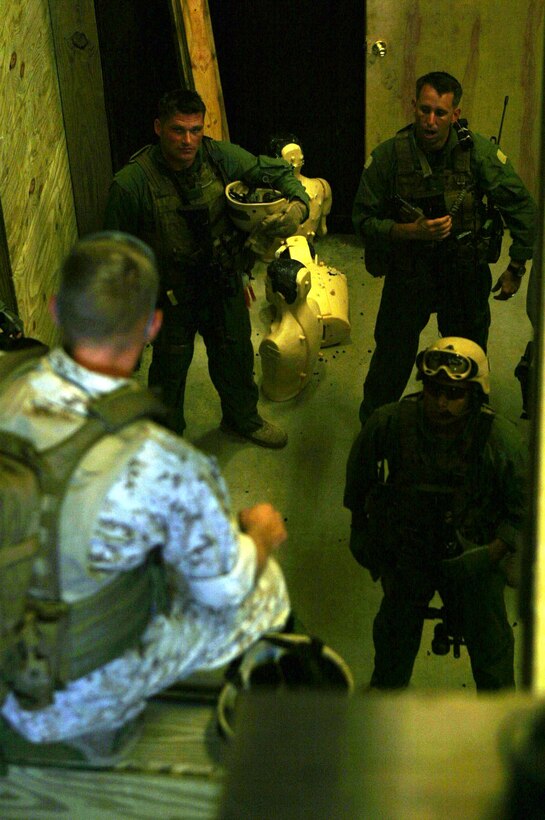 A Tactics instructor with Marine Special Operations School conducts an after-action assessment with Marines from 2d Marine Special Operations Battalion during close-quarters battle training here. The training was part of a five week direct action course here to prepare Marine Special Operations Companies for worldwide deployment.