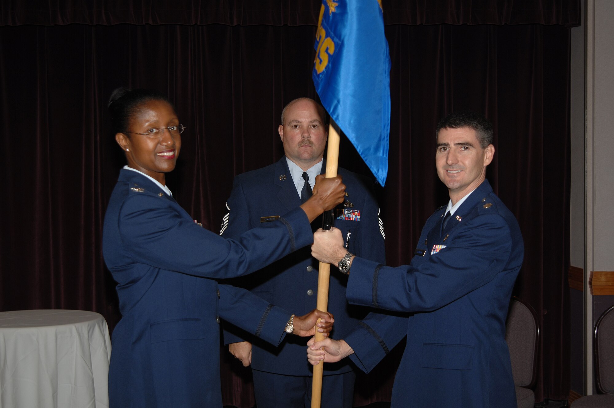 WHITEMAN AIR FORCE BASE, Mo. - Left: Col. Gloria Twilley, 509th Medical Group commander, passes the guidon of the 509th Medical Operations Squadron to Lt. Col. Brian Stanton during an assumption-of-command ceremony Sept. 7. Colonel Stanton was previously assigned to the 6th MDG at MacDill Air Force Base, Fla. Lt. Col. Jeffery Johnson, the former 509th MDOS commander, has moved on to the U.S. Air Force Academy. (U.S. Air Force photo/Senior Airman Lauren Padden) 