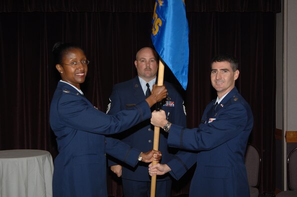 WHITEMAN AIR FORCE BASE, Mo. - Left: Col. Gloria Twilley, 509th Medical Group commander, passes the guidon of the 509th Medical Operations Squadron to Lt. Col. Brian Stanton during an assumption-of-command ceremony Sept. 7. Colonel Stanton was previously assigned to the 6th MDG at MacDill Air Force Base, Fla. Lt. Col. Jeffery Johnson, the former 509th MDOS commander, has moved on to the U.S. Air Force Academy. (U.S. Air Force photo/Senior Airman Lauren Padden) 