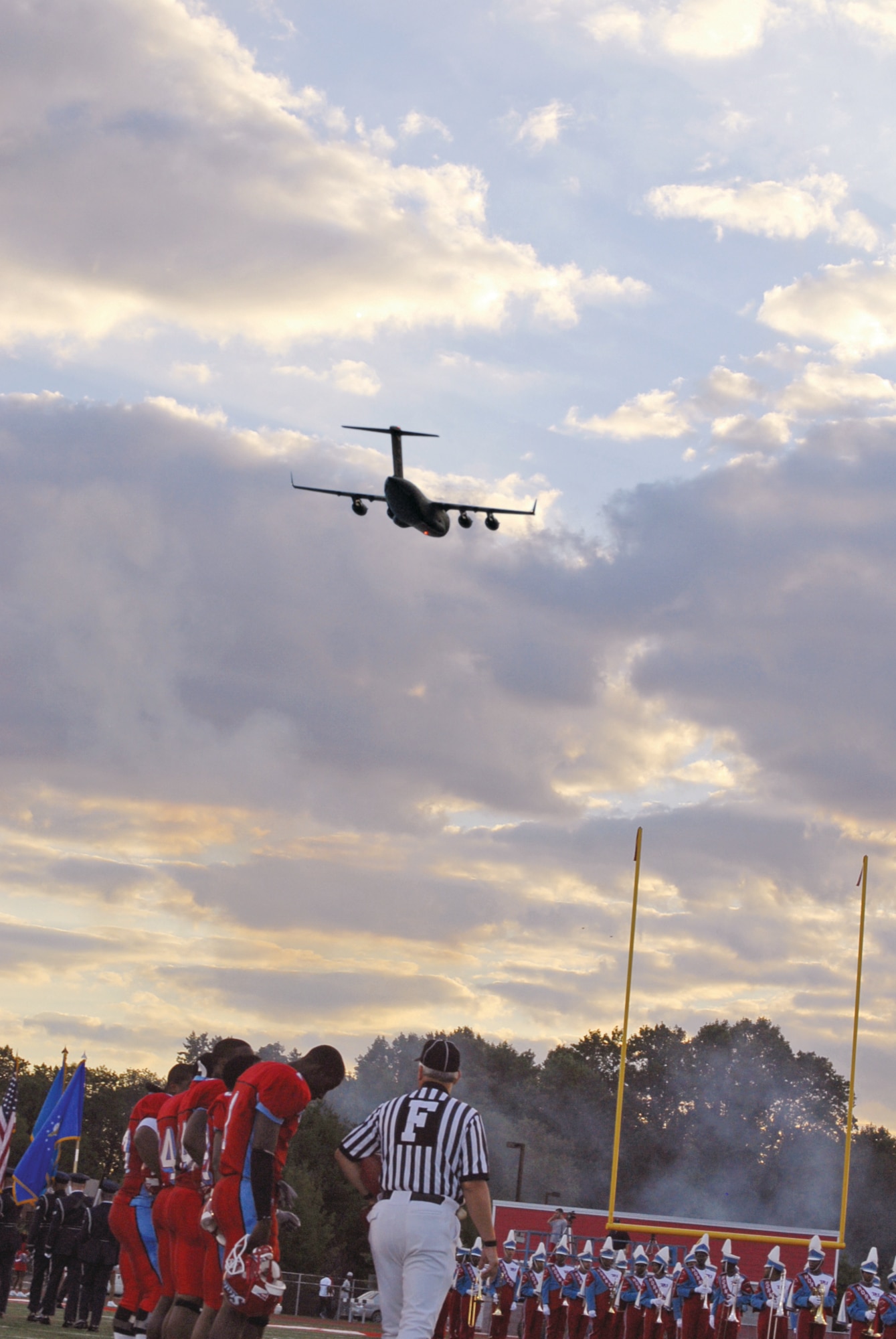 One of Dover Air Force Base’s new C-17 Globemaster III airlifters flies over the Deleware State University football stadium Saturday during military appreciation night. All servicemembers in uniform got to watch the game for free. (Photo by Tech. Sgt. Kevin Wallace.)