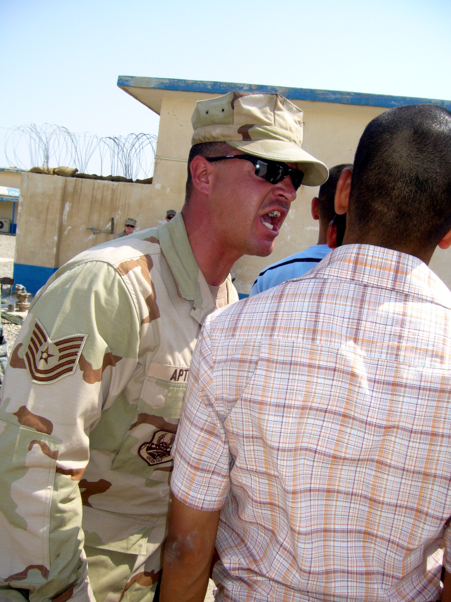 Tech. Sgt. Justin Apticar welcomes members of the second class of Iraqi Officer Training Cadets to the Air Force Training Academy Aug. 28 at Camp Taji, Iraq. Sergeant Apticar is a member of the Coalition Air Force Transition Team, and is deployed from the 737th Training Group at Lackland Air Force Base, Texas. (U.S. Air Force photo/Maj. Edwina Walton)