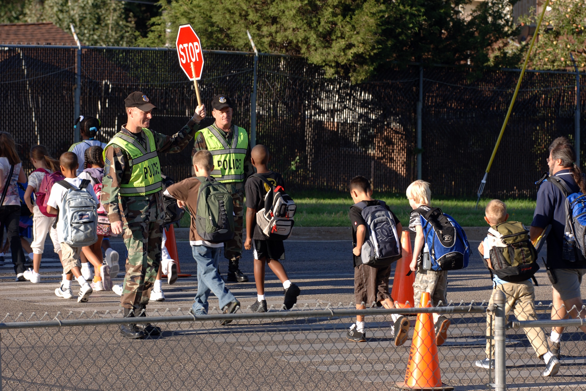Chief Master Sgt. William Gurney, 75th Air Base Wing and Ogden Air Logistics Center command chief master sergeant, and Col. Scott Chambers, 75th ABW commander, perform the first crossing guard duty of the year Aug. 29. Because the 75th Security Forces Squadron is no longer authorized to peform crossing guard duties, volunteers are needed. Anyone wishing to volunteer should call Master Sgt. Kraig Chapman at 777-3745. (U.S. Air Force Photo by Alex R. Lloyd)