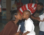 Staff Sgt. Lashana Rivers gives her 4-year-old, Deandre, a goodbye kiss before sending him off to his first day of school Aug. 27, 2007, at the Lackland Elementary School. Sergeant Rivers is assigned to the 59th Diagnostics and Therapeutics Squadron. (USAF photo by Alan Boedeker)                               