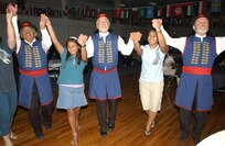 Members of Team Lackland participate with dancers from the Mazuka Polish Dancers of San Antonio. The Polish Dancers were just  one of several entertainment featured at the Internataional Cultural Festival held at Arnold Hall on Lackland AFB, Texas, Aug. 25, 2007. (USAF photo by Alan Boedeker)                               