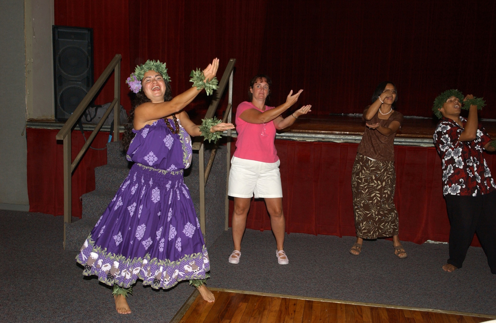 Janet Rodriguez from the Hula Hulao Ohana Eikapeka dance troupe demonstrates the Hukilau (fish with a net) during one of  the many performances held at Arnold Hall during the International Folk Festival Aug. 25, 2007, at Lackland AFB, Texas. (USAF photo by Alan Boedeker)                               