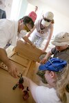 A group of volunteers from the Lackland AFB, Texas, civil engineering family assemble a kitchen cabinet in a Habitat for Humanity home in Palo Alto on Aug. 11, 2007. (USAF photo by Robbin Cresswell)