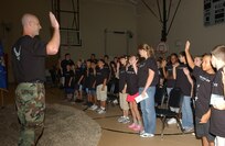 Capt. Russell "Bus" Callaway, 37th Military Personnel Flight commander at Lackland AFB, Texas, swears in the new Airmen before sending them on their half-day deployment on Aug. 10, 2007. (USAF photo by Alan Boedeker)                               