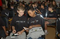 Zach Fox, left, and Darren Chargualaf thumb through a pocket-size Bible that was distributed at the chapel's deployment station during Operation JET Aug. 10, 2007, at Lackland AFB, Texas. Zach is the son of Master Sgt. Lisa Fox-Simmons, Air Force Intelligence, Surveillance and Reconnaissance Agency, and Tech. Sgt. Gregory Fox, 37th Logistics Readiness Squadron. (USAF photo by Alan Boedeker)
                               