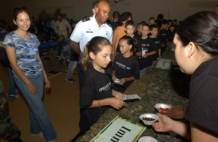 Martha Deluzio takes her required Anthrax immunization, represented by a purple Skittle, during the deployment processing line Aug. 10, 2007. Youths attending Operation JET visited several stations during before deploying to Camp Freedom at Lackland AFB, Texas, including uniform issue, immunizations, legal services and chapel briefings. Martha is the daughter of Master Sgt. Sarah and Tech. Sgt. Anthony Deluzio, both assigned to the 37th Training Wing. (USAF photo by Alan Boedeker)                              