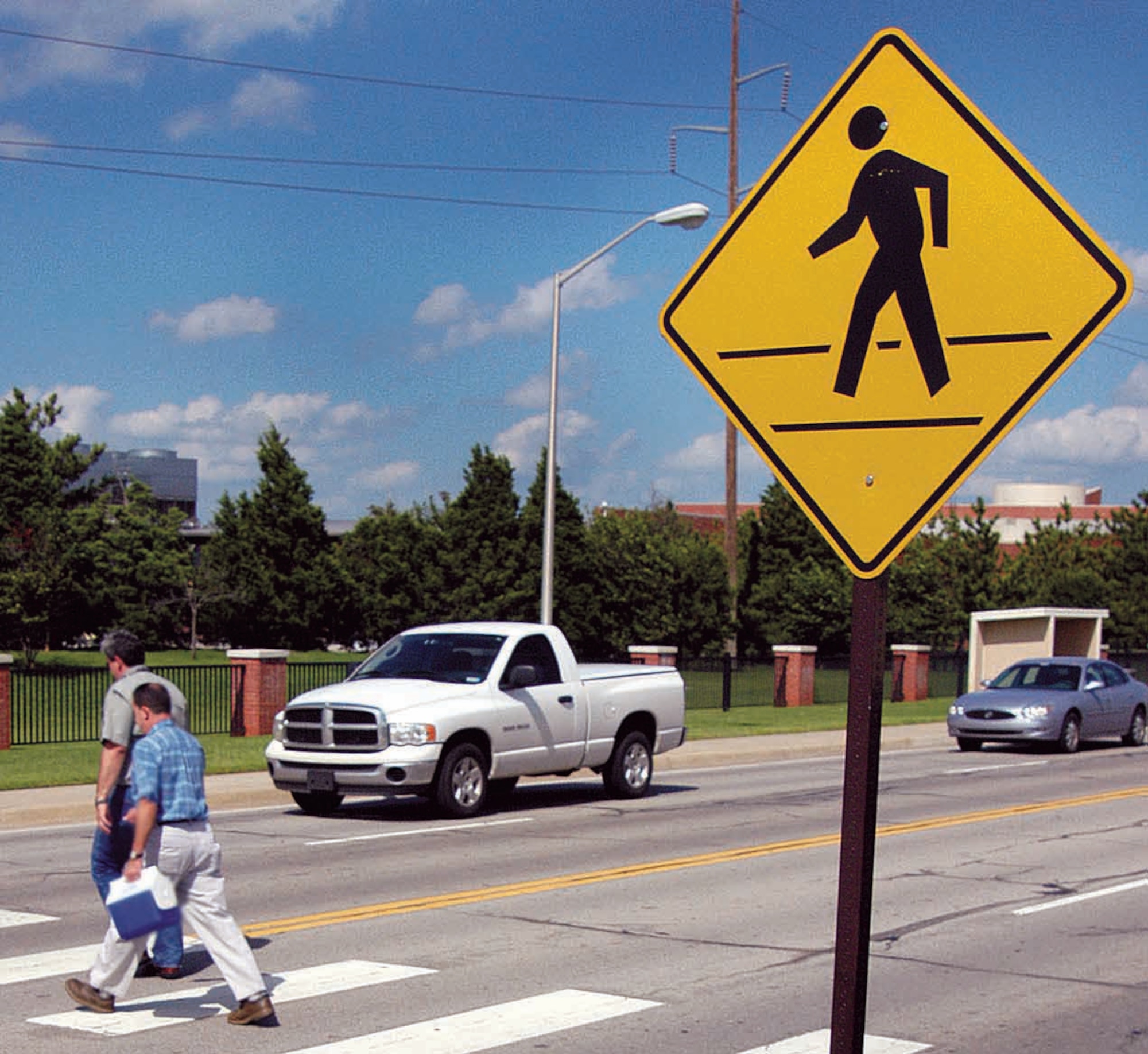 According to Oklahoma state law, pedestrians who do not use a crosswalk must yield the right of way to vehicles. Pedestrians should always make eye contact with drivers before crossing the street. (Air Force photo by Margo Wright)