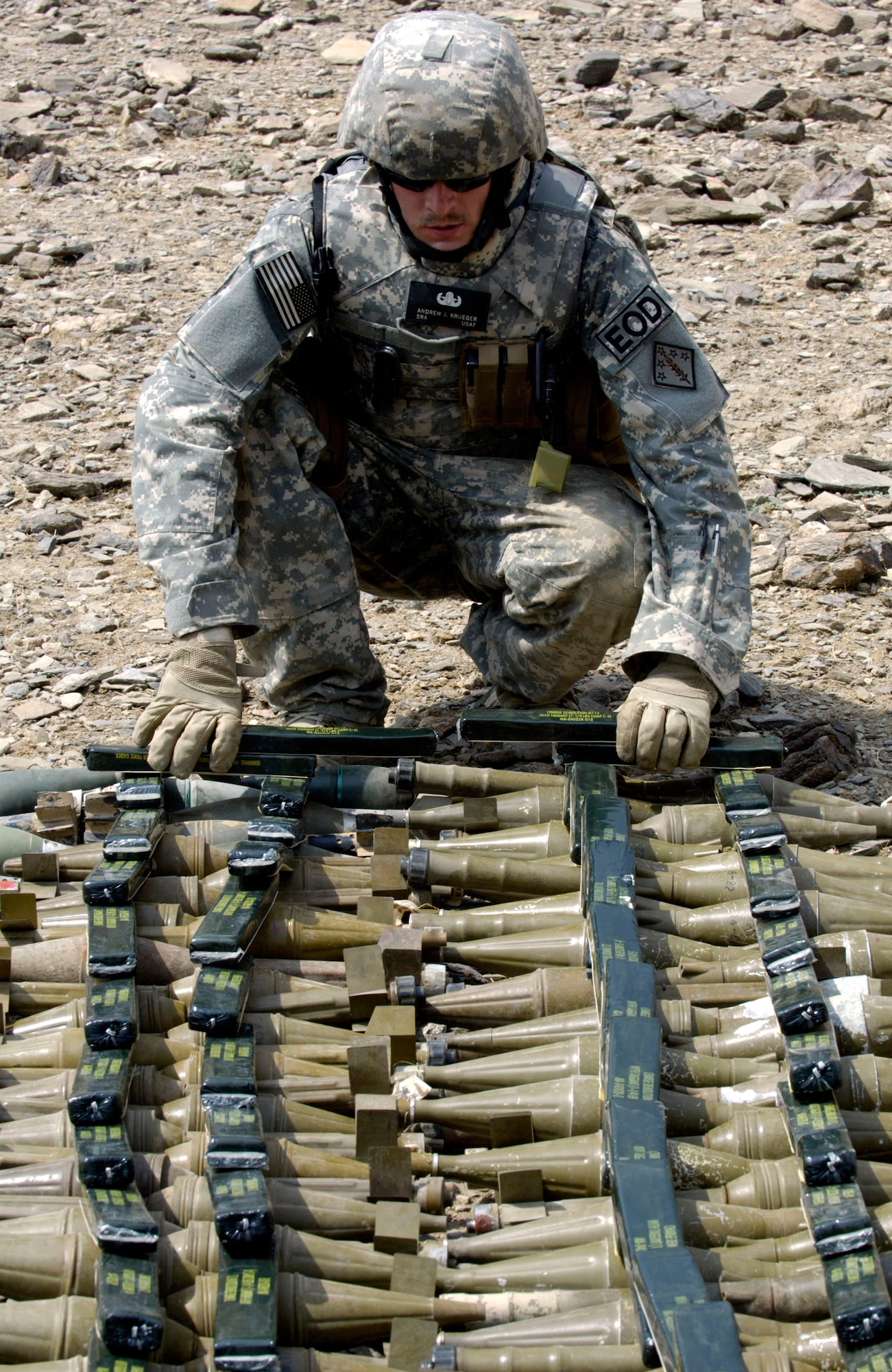 An Air Force explosive ordnance disposal specialist from Forward Operating Base Mehtar Lam, Afghanistan, readies ammunition for a controlled detonation Sept. 1. Nearly 900 pounds of small arms ammunition, rocket-propelled grenades and mortars were turned in by provincial citizens. (U.S. Air Force photo/Master Sgt. Jim Varhegyi) 
