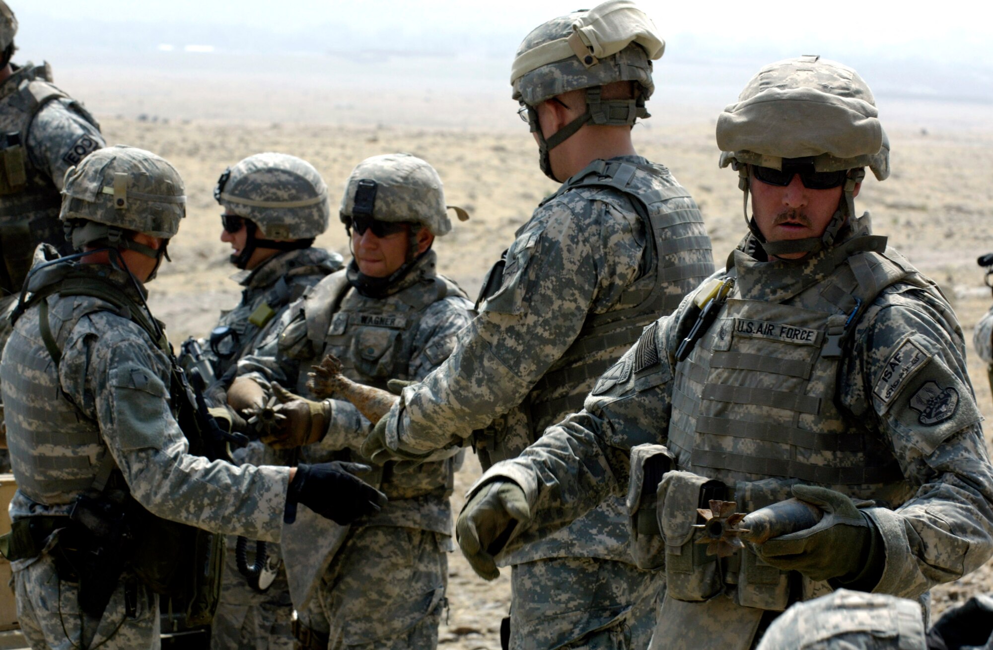 Air Force explosive ordnance disposal specialists from Forward Operating Base Mehtar Lam, Afghanistan, ready ammunition for a controlled detonation Sept. 1. Nearly 900 pounds of small arms ammunition, rocket-propelled grenades and mortars were turned in by provincial citizens. (U.S. Air Force photo/Master Sgt. Jim Varhegyi) 
