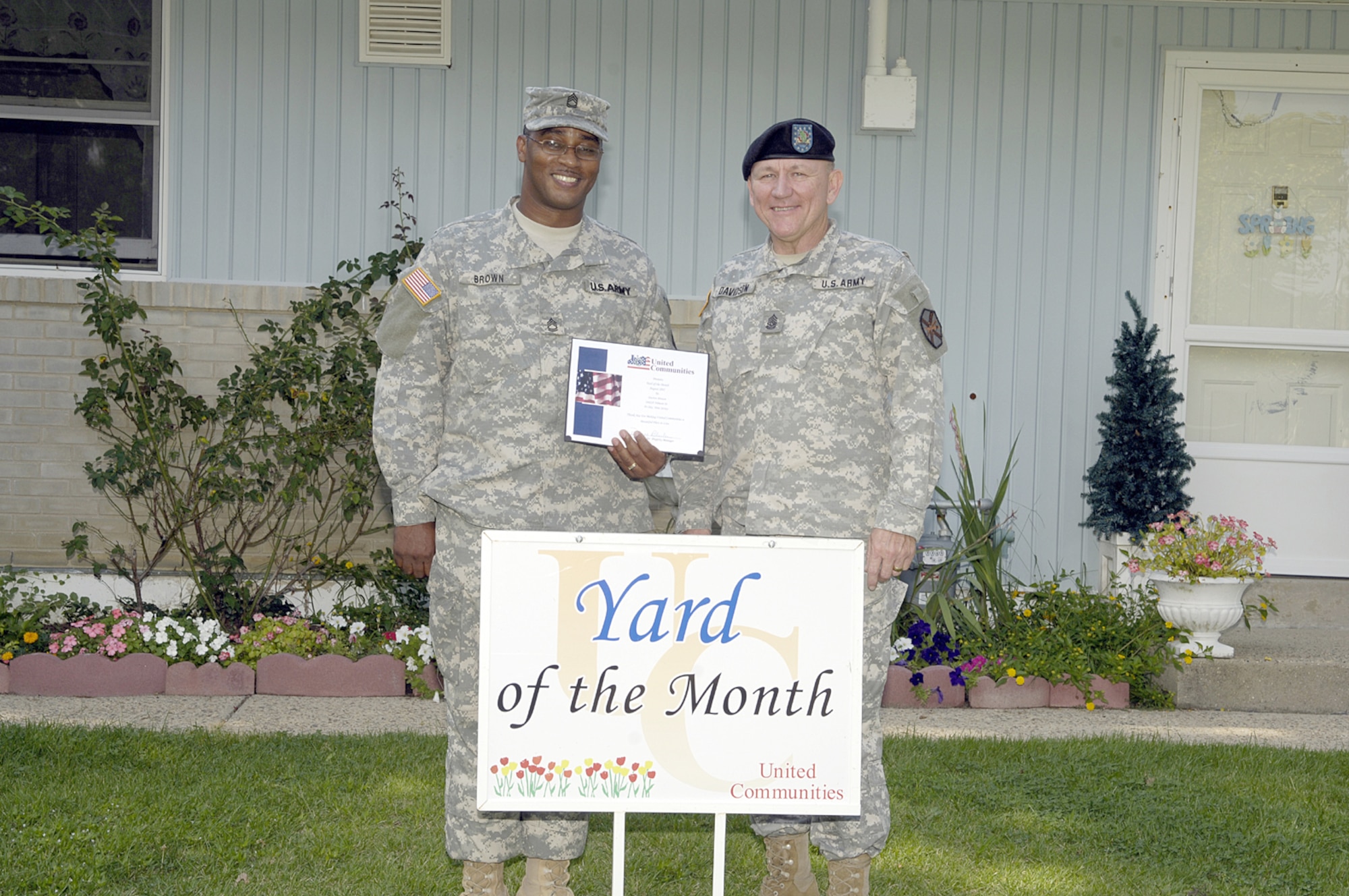 Sgt. 1st Class Darren Brown accepts Yard of the Month from Command Sgt. Maj. Ken Davidson, Fort Dix. Each month during the summer, one Yard of the Month and one Honorary Yard of the Month are selected in the McGuire and Fort Dix housing areas.