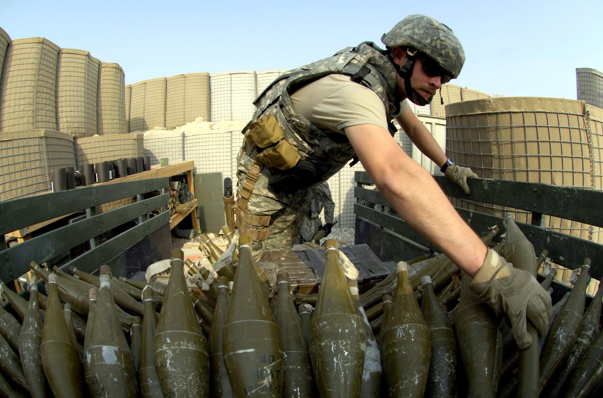 An Air Force explosive ordnance disposal specialist readies ammunition for a controlled detonation Sept. 1 at Forward Operating Base Mehtar Lam, Afghanistan. Nearly 900 pounds of small arms ammunition, rocket-propelled grenades and mortars were turned in by provincial citizens. (U.S. Air Force photo/Master Sgt. Jim Varhegyi)
