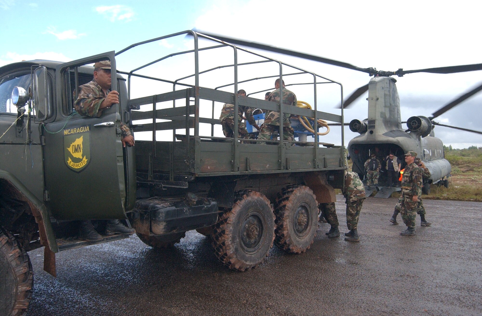 PUERTO CABEZAS, Nicaragua -- Members of the Nicaraguan army offload relief supplies from a CH-47 Chinook helicopter here Sept. 7.  A team from Joint Task Force-Bravo in Honduras is deployed to Nicaragua supporting relief efforts following landfall of Hurricane Felix.  U.S. Air Force photo by Tech. Sgt. Sonny Cohrs.                               