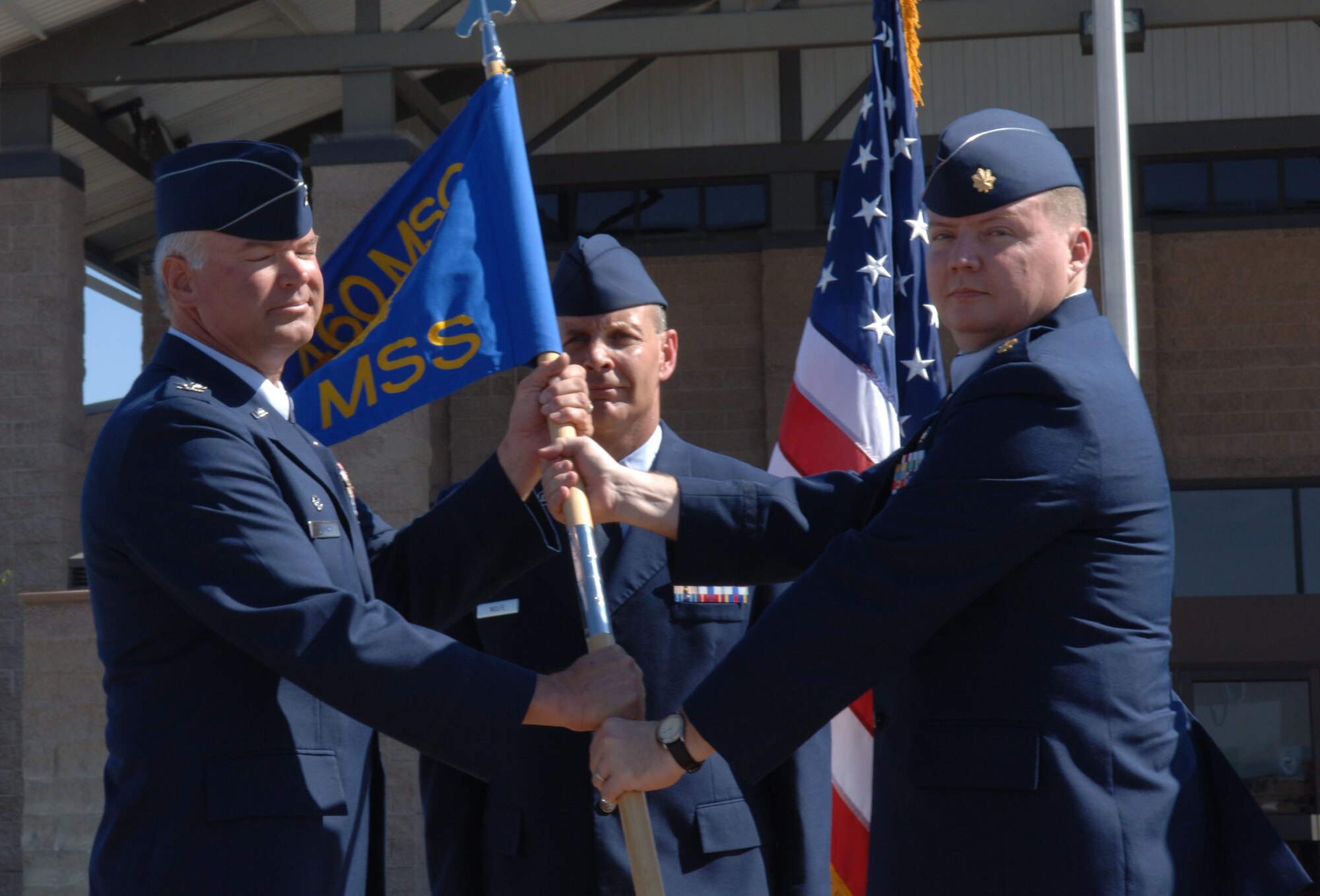 Col. Bart Hedley, 460th Mission Support Group commander, hands command of the 460th Mission Support Squadron to Maj. Thomas Smith during a ceremony Sept. 5. Major Smith assumed command from Lt. Col. Craig DeZern. Colonel DeZern is staying at Buckley to become the 460th Space Wing's director of staff. (U.S. Air Force photo by Airman 1st Class Chris Bush)
