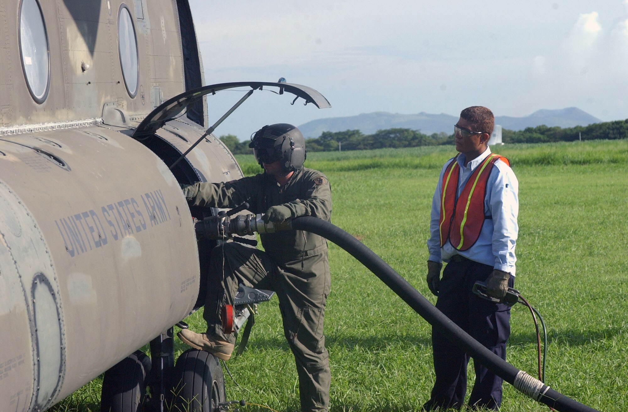 A loadmaster from Soto Cano Air Base refuels a Joint Task Force-Bravo UH-47 Chinook on the tarmac at Managua, Nicaragua with the help of a Nicaraguan Airport worker.  The UH-47 was enroute to Puerto Cabezas, Nicaragua, carrying supplies and communications equipment for the U.S. military assessment team from Soto Cano that arrived in Nicaragua Sept. 5.  The U.S. military is working with the U.S. State Department and Nicaraguan officials to provide relief to Nicaraguans in need in the wake of Hurricane Felix. U.S. Air Force photo by 1st Lt. Erika Yepsen.                               