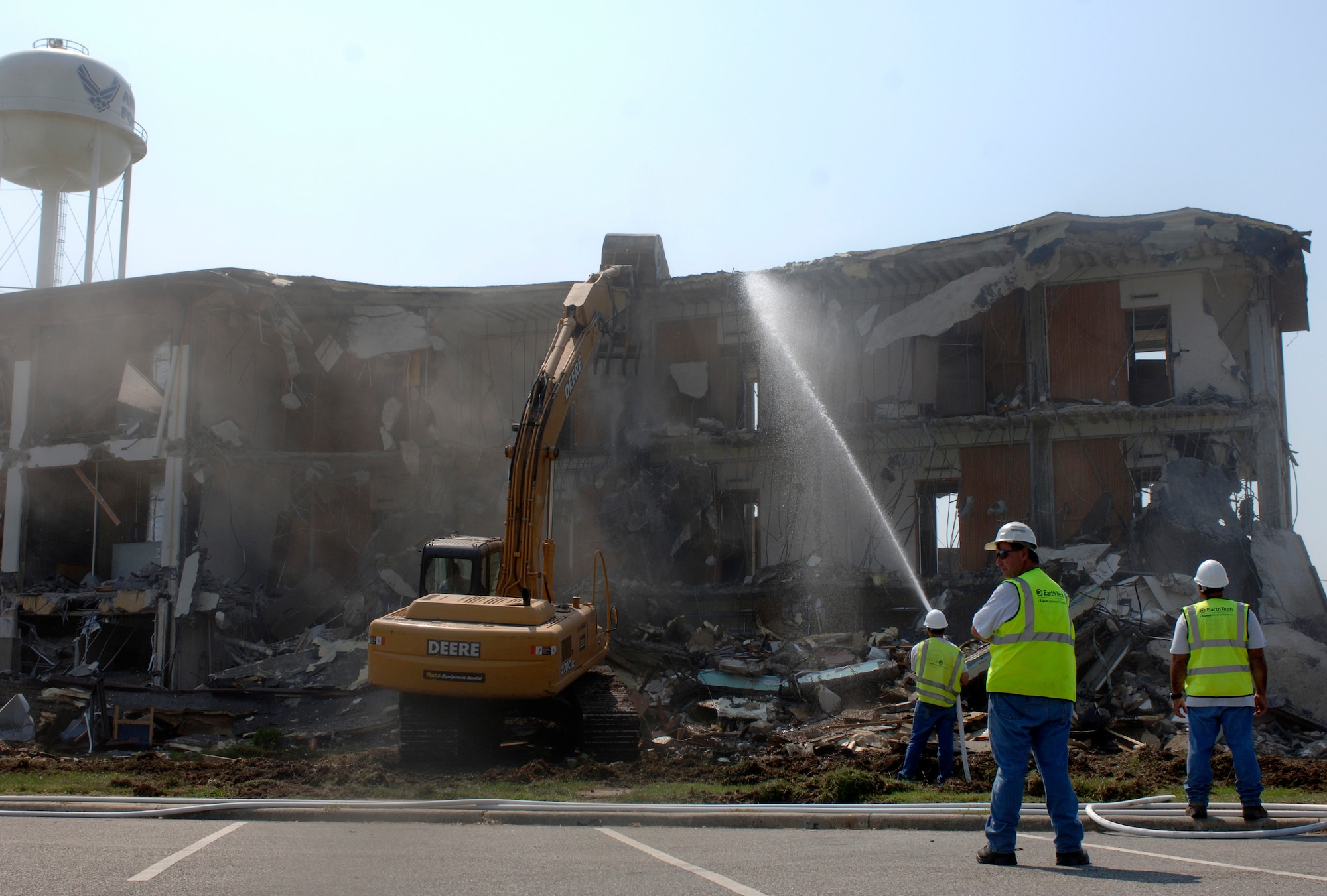 Two contractors from Earth Tech monitor the demolition of the former Langley Inns building while a third uses water to contain the debris to the site Sept. 6. Once demolition is complete, workers will begin planning for construction of the new three-story lodging office, which is scheduled to begin in spring 2008. (U.S. Air Force photo/Airman 1st Class Vernon Young)