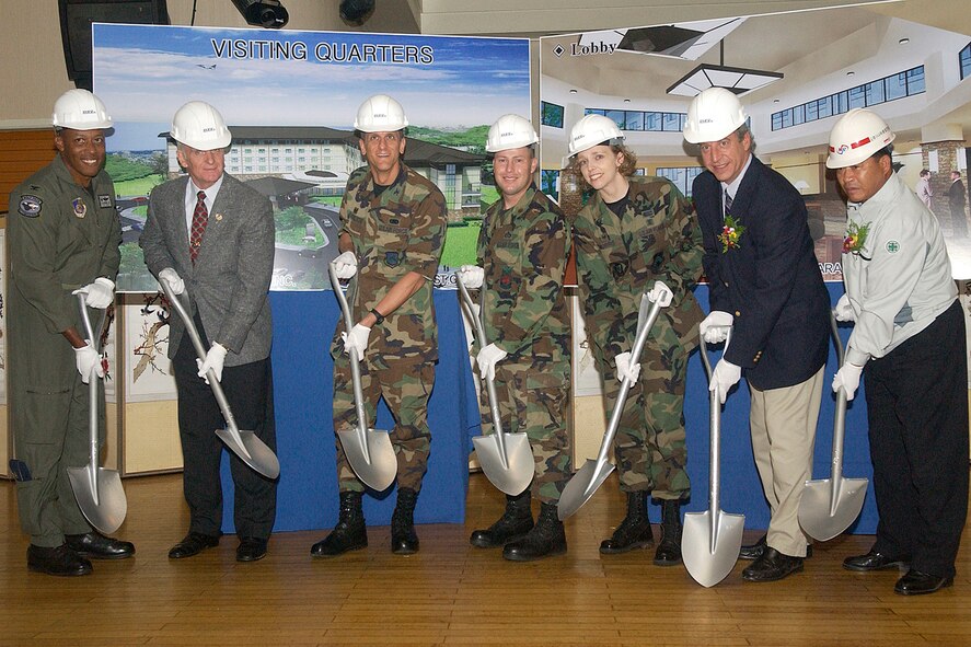 KUNSAN AIR BASE, South Korea -- The base's official party simulates breaking ground on a new lodging facility during a ceremony Sept. 7 here. The ceremony highlights the base's new lodging facility currently under construction. The new facility, scheduled to open in July 2009, aims to "improve base morale by enhancing the quality of life for visiting Airmen," according to Col. CQ "Wolf" Brown, 8th Fighter Wing commander. The official party includes (left to right) Colonel Brown, Mr. Arthur J. Myers, Air Force Services director, Col. Timothy "Falcon" Sakulich, 8th Mission Support Group commander, Maj. Richard Mathews, 8th Civil Engineer Squadron commander, Maj. Sirena Morris, 8th Services Squadron commander, Mr. Gerry Castelli, Pacific Area manager for Toltest Inc. and Mr. Han, Tak Su from the Nara Construction Company. Toltest Inc. was awarded the contract to construct the new facility. (U.S. Air Force photo/Senior Airman Giang Nguyen)                               
