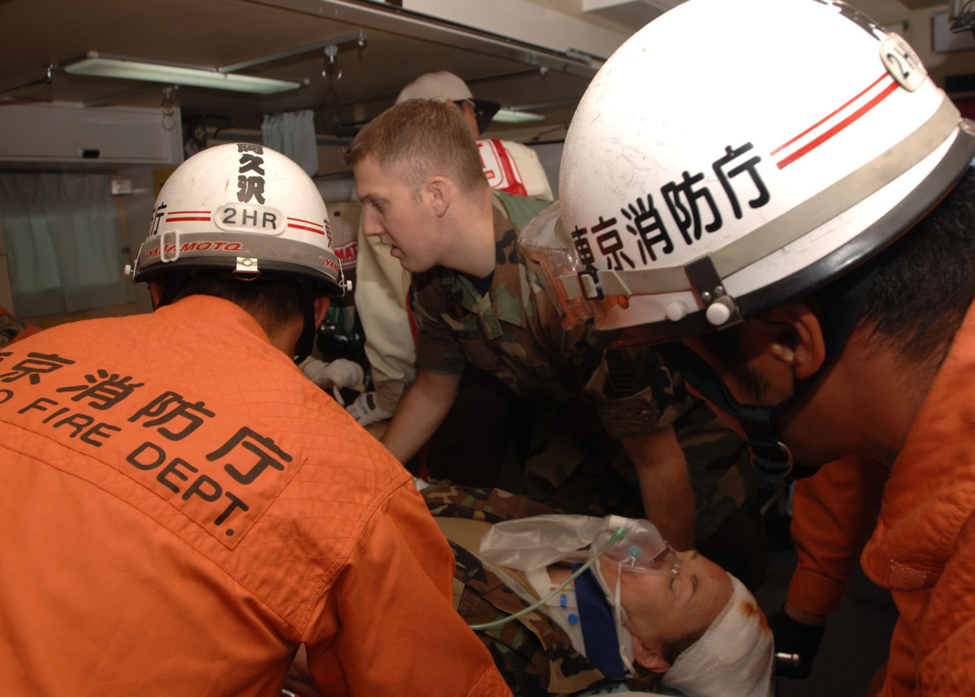 070901 YOKOTA AIR BASE, Japan -- Personnel from the 374th Airlift Wing and the Tokyo Metropolitan Fire Department work together to provide emergency care to simulated patients for a Joint Disaster Management Exercise held by the Tokyo Metropolitan Government on the Yokota Air Base flightline. In Japan, 1 September is established for Disaster Awareness (Readiness) Day  as known as Bo-sai-no-hi after the Great Kanto Earthquake in 1923 this exercise helps prepare the Japanese citizens for future disasters. Yokota has participated in the TMG exercise since 2001.
(U.S. Air Force photo by A1C Laszlo Babocsi)

