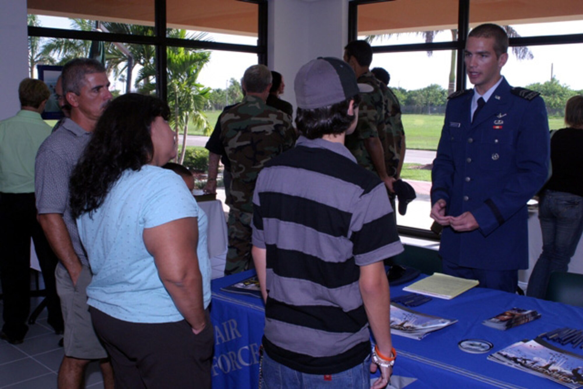 An interested high school student and his family talk with a representative from the U.S. Air Force Academy at an information tables during the Rep. Mario Diaz-Balart Service Academy Day at Homestead Air Reserve Base on September 8. The students met with representatives from the Air Force, Coast Guard, U.S. Military, Naval and Merchant Marine academies at the Heritage Hall Training and Conference Center to discuss and learn about the educational and career opportunities available at the respective academies. (U.S. Air Force photo/Tech. Sgt. Paul Dean)