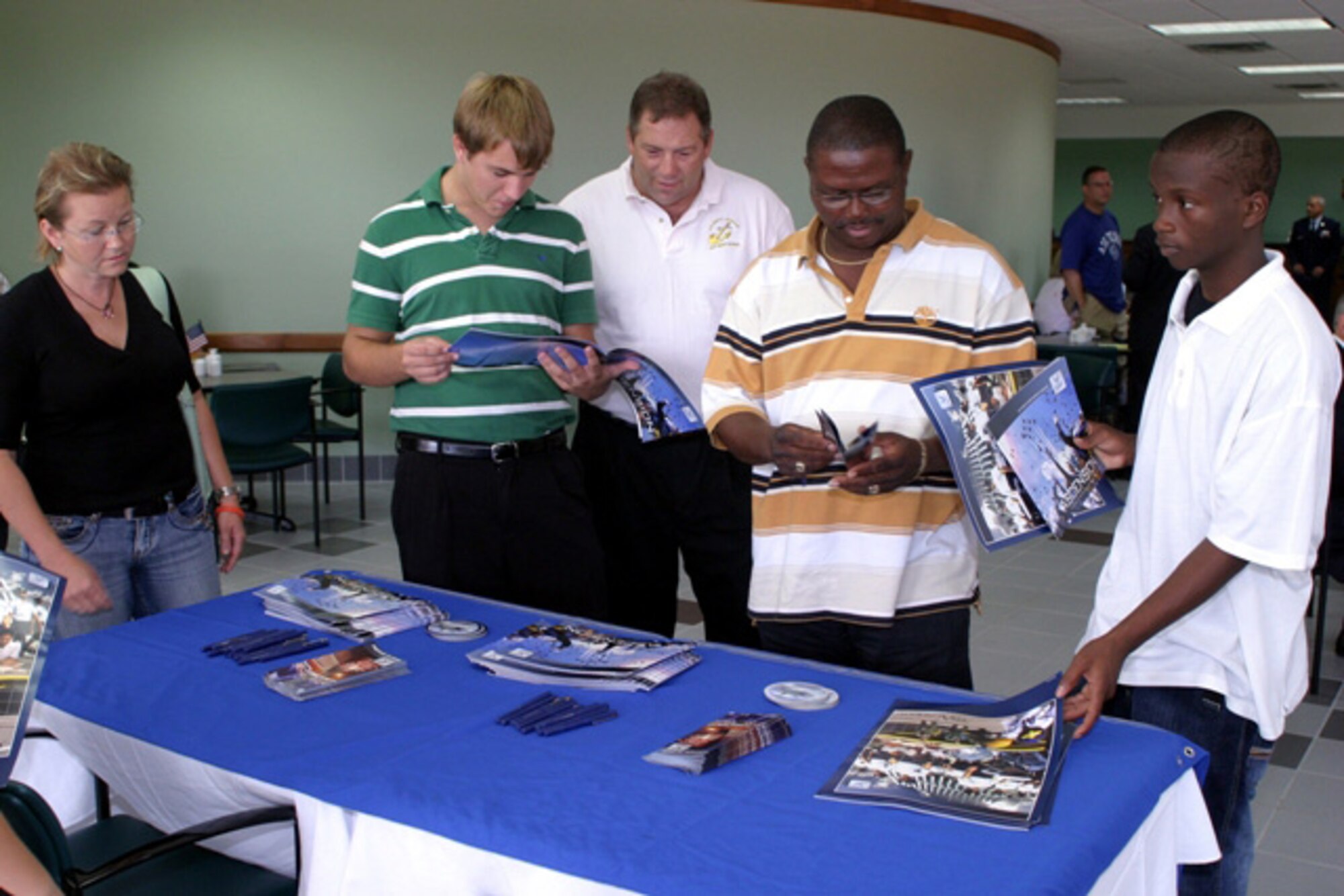 Local high school students and family members look through brochures on information tables set up at the Rep. Mario Diaz-Balart Service Academy Day at Homestead Air Reserve Base on September 8. The students met with representatives from the Air Force, Coast Guard, U.S. Military, Naval and Merchant Marine academies at the Heritage Hall Training and Conference Center to discuss and learn about the educational and career opportunities available at the respective academies. (U.S. Air Force photo/Tech. Sgt. Paul Dean)