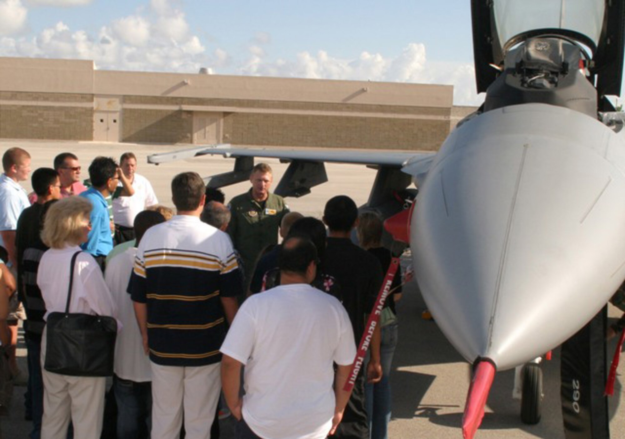 A 93rd Fighter Squadron pilot (center) gives a tour of an F-16C Fighting Falcon aircraft during the Rep. Mario Diaz-Balart Service Academy Day at Homestead Air Reserve Base on September 8. Approximately 15 local high school students and their families met with representatives from the Air Force, Coast Guard, U.S. Military, Naval and Merchant Marine academies at the Heritage Hall Training and Conference Center to discuss and learn about the educational and career opportunities available at the respective academies. (U.S. Air Force photo/Senior Airman Erik Hofmeyer)