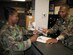 SEYMOUR JOHNSON AIR FORCE BASE, N.C. - Senior Master Sgt. Andre Kirk (right) and Tech. Sgt. Diane Speas are just two of the air reserve technicians implementing the new uniform policy at the 916th Air Refueling Wing. The policy went into effect in August throughout Air Force Reserve Command.