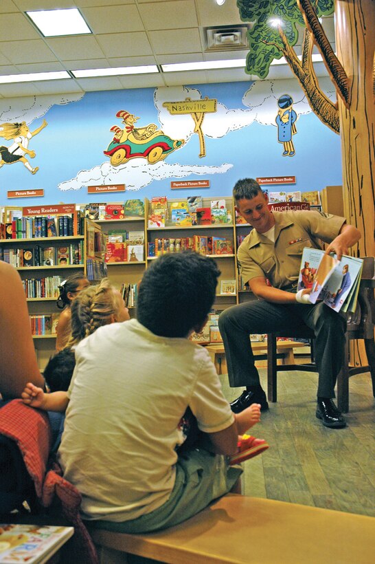 Cpl. Andrew Russell, Headquarters and Headquarters Squadron Marksmanship Training Unit primary marksmanship instructor, reads to children attending the fifth annual American Heroes Book Fair Sept. 8 at the Yuma Barnes and Noble. The event was organized by the Yuma Reading Council and Friends of the Library, and aimed to promote literacy as well as honor service members and the events of Sept. 11, 2001.