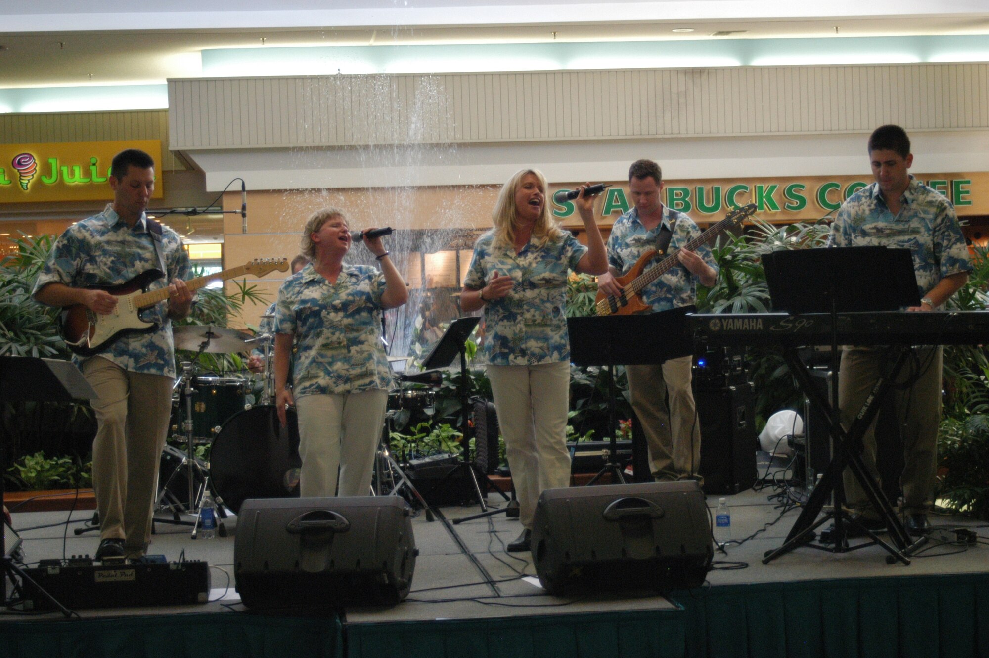 On day three of Air Force Week Honolulu, "Top Cover" USAF Band of the Pacific from Alaska performs for a crowd of more than 200 at local Oahu shopping mall. Wearing their Air Force 60th Anniversary special edition "Aloha shirt" from left to right are band members: Tech. Sgt. Rick Baisden, Master. Sgt. Judi, Westfall, Master. Sgt. Scott Weller, Staff. Sgt. Alyson Jones, Staff. Sgt. Josh Holdridge, Senior Airman Matthew Peacock and Staff. Sgt. BJ Fine (Audio Tech not shown). (USAF photo by Tech. Sgt. Tom Czerwinski)
