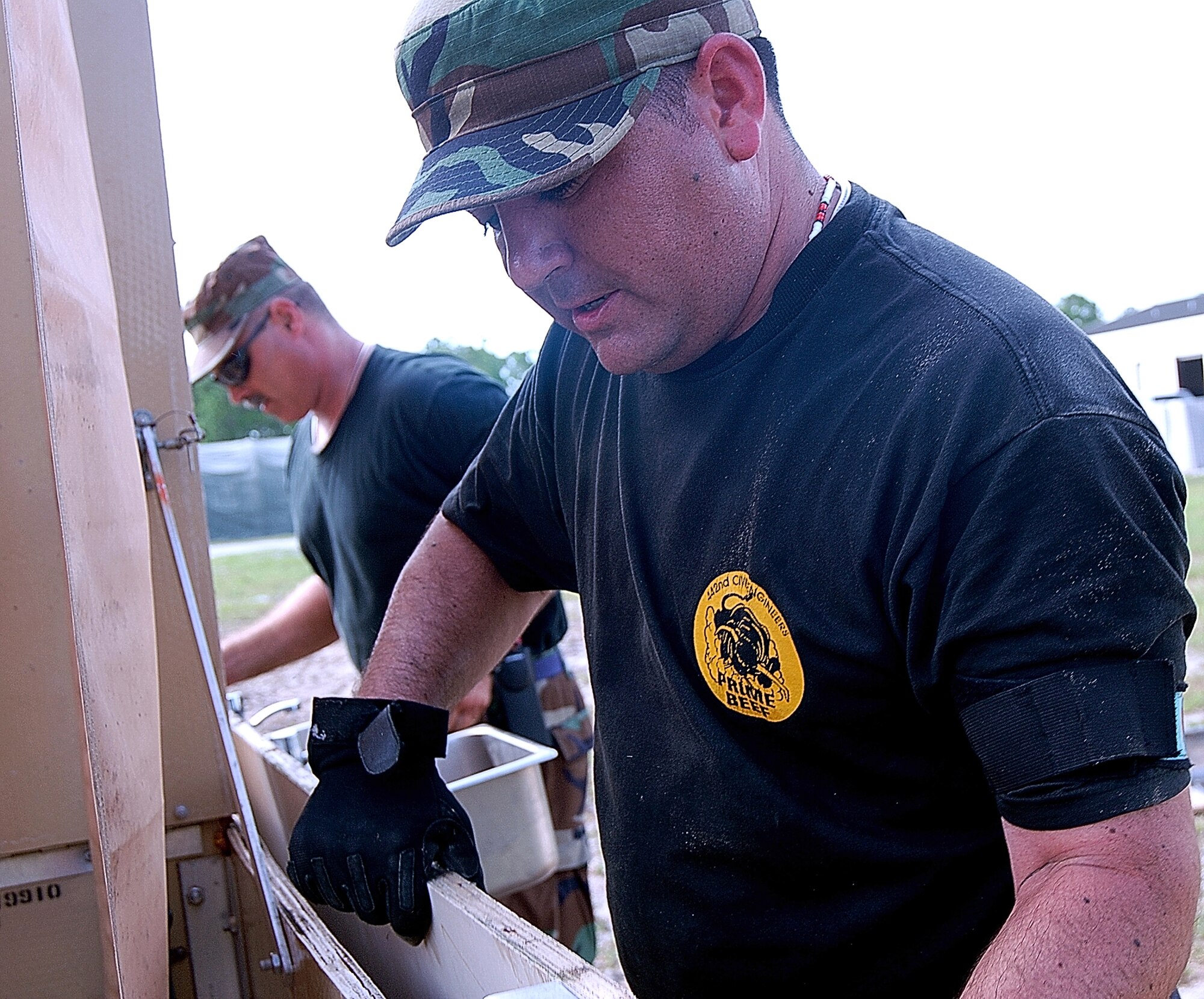 Master Sgt. Kurt Kissel and Tech Sgt. Nathan Hooton hang wash basins on a portable latrine facility they had to assemble during a Silver Flag exercise. The 442nd Civil Engineer Squadron Airmen from Whiteman Air Force Base, Mo., deployed to the exercise site at Tyndall AFB, Fla. to hone their contingency skills.  (US Air Force photo/Master Sgt. Bill Huntington)