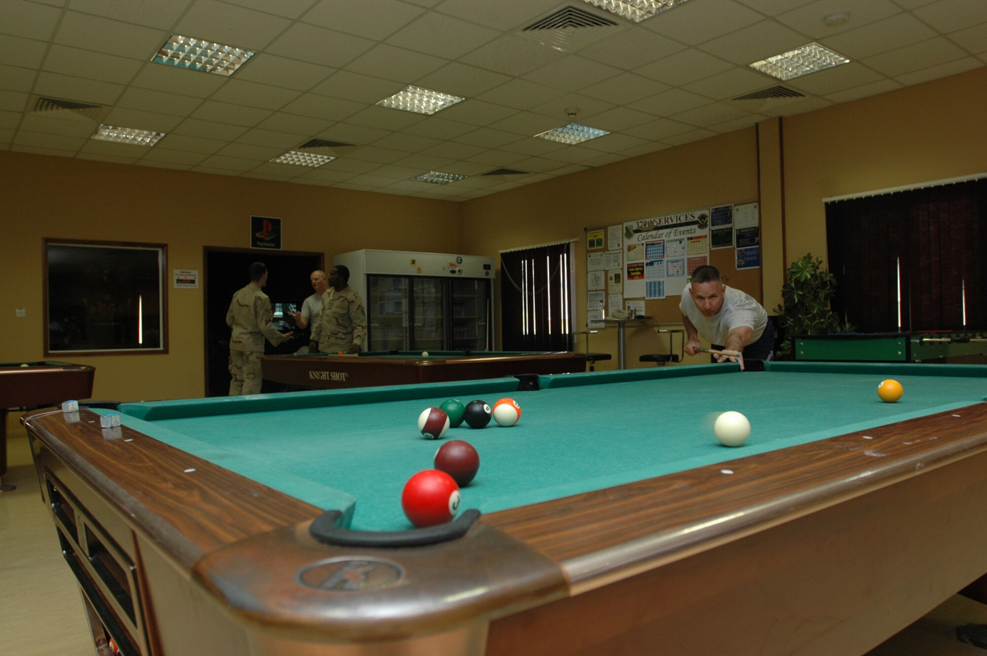 Lt. Col. Larry Audte sinks a ball in a game of pool at the Community Activity Center Wednesday. Colonel Audte was here for several days, en route from Baghdad to his new assignment at the Pentagon. He is one of many transient personnel who will be spending time here while they await transportation in and out of the area of responsibility. (U.S. Air Force photo by Senior Airman Clark Staehle)