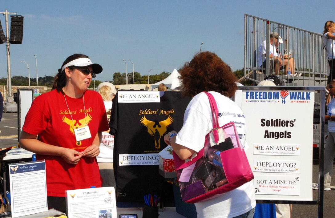 Karina Rollins (right), talks with Lisa Dixon of Soldiers' Angels after participating in the third America Supports You Freedom Walk on Sept. 9, 2007, in Washington. The troop-support group, one of 21 participating in the event following the walk, offers a variety of support to servicemembers including letters and care packages. Photo by Samantha L. Quigley