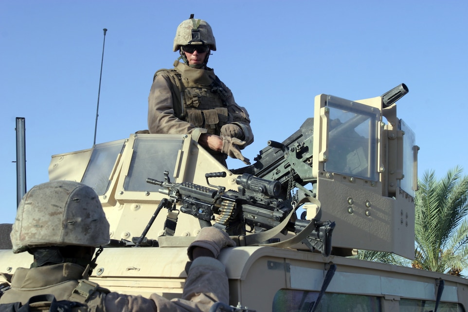 Marines with Company K, 3rd Battalion, 3rd Marines Regiment, Regimental Combat Team 6, stationed at Camp Fallujah, patrol through a small village north of Karmah, Iraq, September 10. Kilo Co. aided the Iraqi locals in establishing an Iraqi Community Watch, a first effort at Iraqi security forces in the region. The ICW will give Coalition Forces an enduring presence in the area to restrict the freedom of movement of terrorist forces.