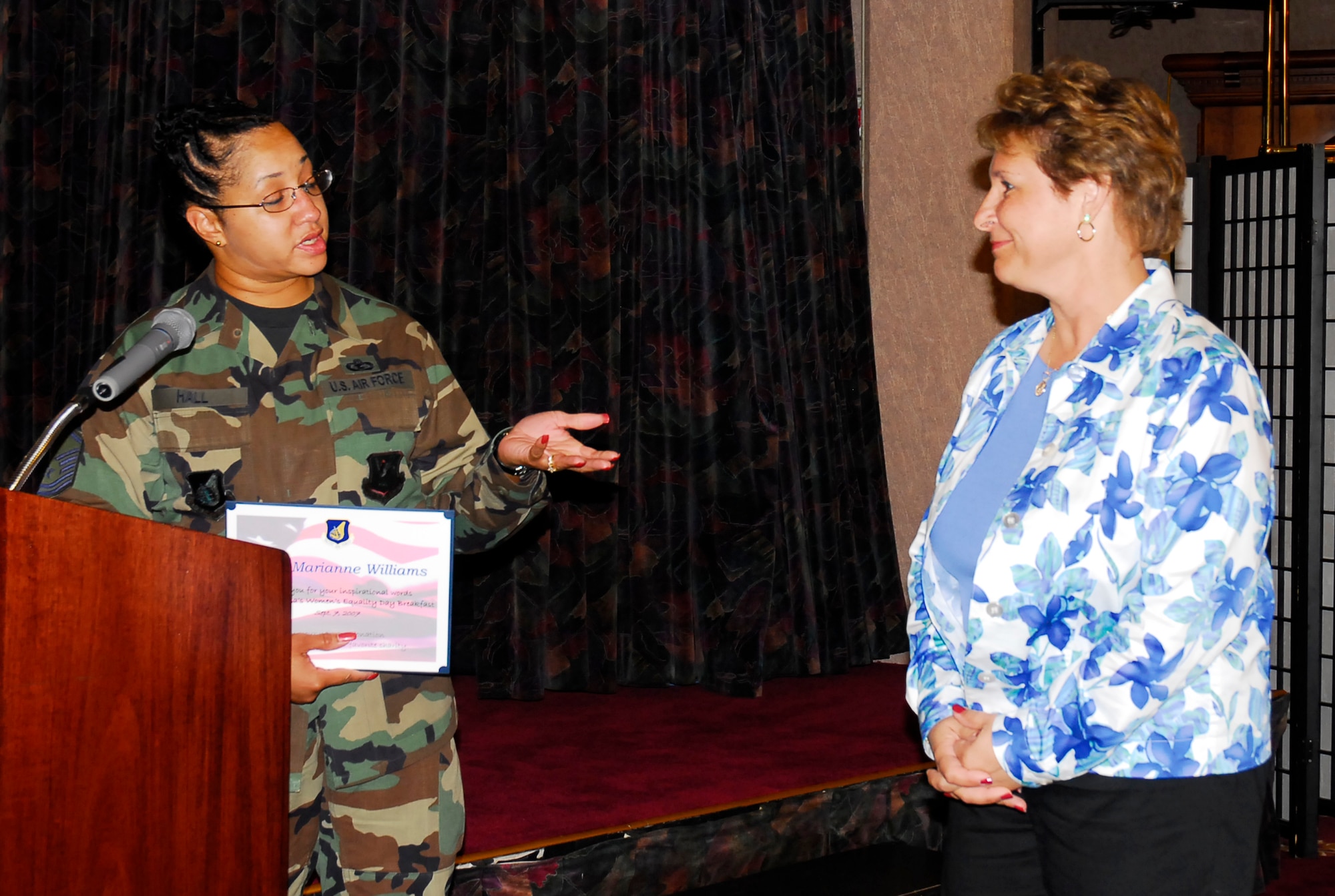 Master Sgt. Theresa Hall, 18th Medical Squadron first sergeant, presents a certificate to Lt. Col. (retired) Marianne Williams, wife of Brig. Gen. Brett Williams, the guest speaker for the Womens Equality event held at Kadena Air Base, Japan, Sept. 7, 2007. Women's Equality Day was commemorated the 1920 passage of the 19th Amendment to the Constitution, granting women the right to vote. (U.S. Air Force photo/Airman 1st Class Sheila deVera) 