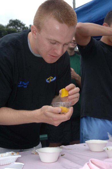 MISAWA AIR BASE, Japan -- A Misawa Airman samples some Japanese appetizers during the Taste of Japan challenge at first Survivor Challenge here on August 31, 2007. Events consisted of the fitness challenge, bag toss and puzzle, canoe course, water balloon launch, taste of Japan, emperor's challenge, and knowledge challenge.(U.S. Air Force photo by Tech. Sgt. Andy Bellamy)