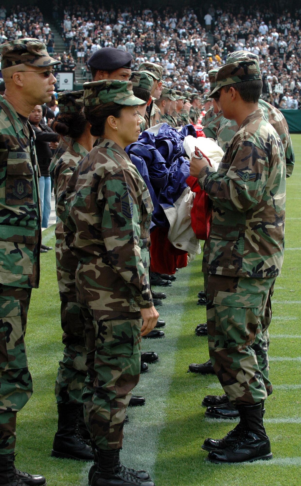 Team Travis Airmen prepare to unfurl the U.S. Flag prior to the Oakland Raiders/Detroit Lions football game Sept. 9 at McAfee Coliseum, Oakland, Calif. The Lions won the game 36-21. (U.S. Air Force photo/Tech. Sgt. Donald Osborn)