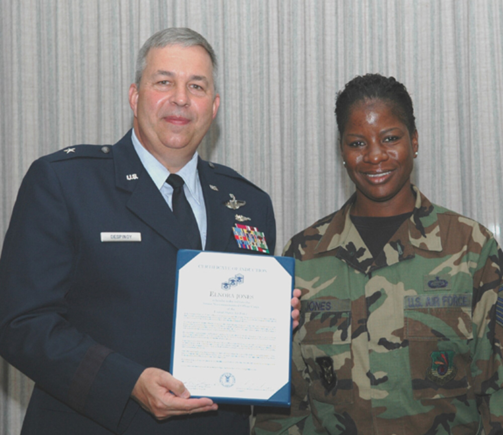 GRISSOM AIR RESERVE BASE, Ind., -- Elnora Jones is presented with a special certificate by Brig. Gen. Dean Despinoy, 434th Air Refueling Wing Commander, to commemorate her promotion to the rank of master sergeant.  More than 40 individuals from the wing were recognized during a special ceremony. Master Sgt. Jones is a member of the wing's Military Equal Opportunity Office.  (U.S. Air Force photo/Senior Airman Chris Bolen)