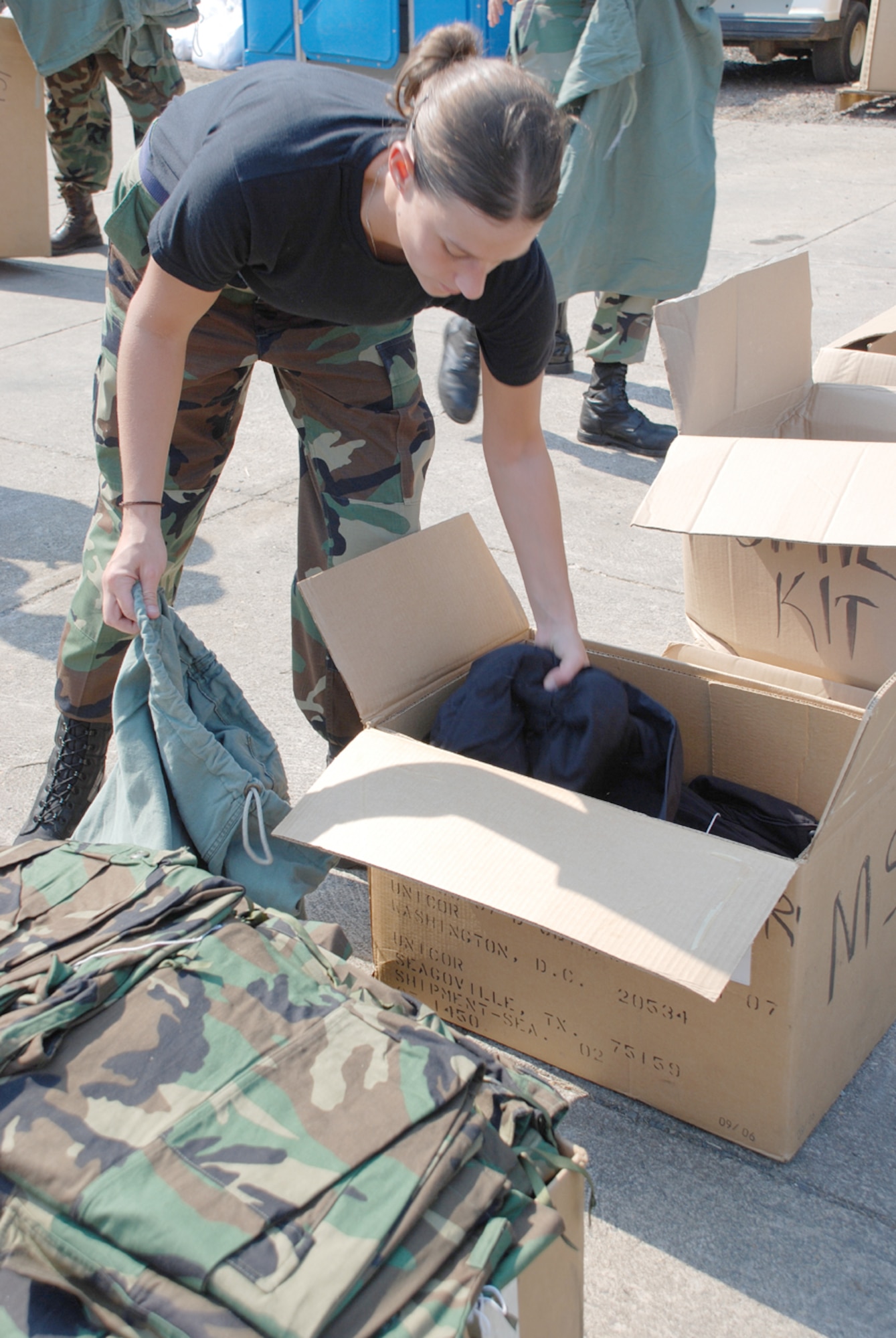 Senior AIrman Jennifer Gayheart, 32nd Air Refueling Squadron boom operator, fills bags with uniforms for military veterans at Operation Stand Down Saturday. The event also offered medical and dental services, food and shelter for the weekend.