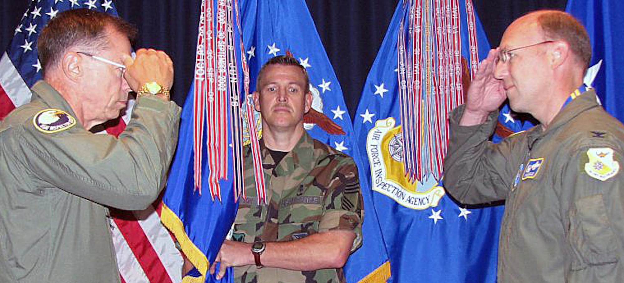 Presenting the Air Force Organizational Excellence Award to the Air Force Inspection Agency, Kirtland AFB, N.M., is Maj. Gen. Jeffrey M. Musfeldt (left), the deputy inspector general of the Air Force, on Aug. 28. Col. Michael J. Kingsley, AFIA commander, accepts the award. Chief Master Sgt. John A. Harrison, AFIA's senior enlisted representative, is the guidon bearer. This is the agency's sixth AFOEA in its 16-year history. The Air Force cited AFIA for achievements in a number of areas, including more than $55 million in cost avoidance and improved combat readiness thanks to its assessments, inspections and consultancy; improving accreditation procedures for clinics; implementing a new mission to oversee and analyze trends in nuclear surety inspections; and revamping TIG Brief magazine, the Air Force's oldest publication. Activated in 1991, AFIA traces its origins to 1927 with the establishment of the Inspection Division under the chief of the Army Air Corps. U.S. Air Force photo by John Clendenin
