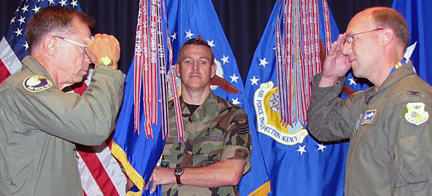 Presenting the Air Force Organizational Excellence Award to the Air Force Inspection Agency, Kirtland AFB, N.M., is Maj. Gen. Jeffrey M. Musfeldt (left), the deputy inspector general of the Air Force, on Aug. 28. Col. Michael J. Kingsley, AFIA commander, accepts the award. Chief Master Sgt. John A. Harrison, AFIA's senior enlisted representative, is the guidon bearer. This is the agency's sixth AFOEA in its 16-year history. The Air Force cited AFIA for achievements in a number of areas, including more than $55 million in cost avoidance and improved combat readiness thanks to its assessments, inspections and consultancy; improving accreditation procedures for clinics; implementing a new mission to oversee and analyze trends in nuclear surety inspections; and revamping TIG Brief magazine, the Air Force's oldest publication. Activated in 1991, AFIA traces its origins to 1927 with the establishment of the Inspection Division under the chief of the Army Air Corps. U.S. Air Force photo by John Clendenin
