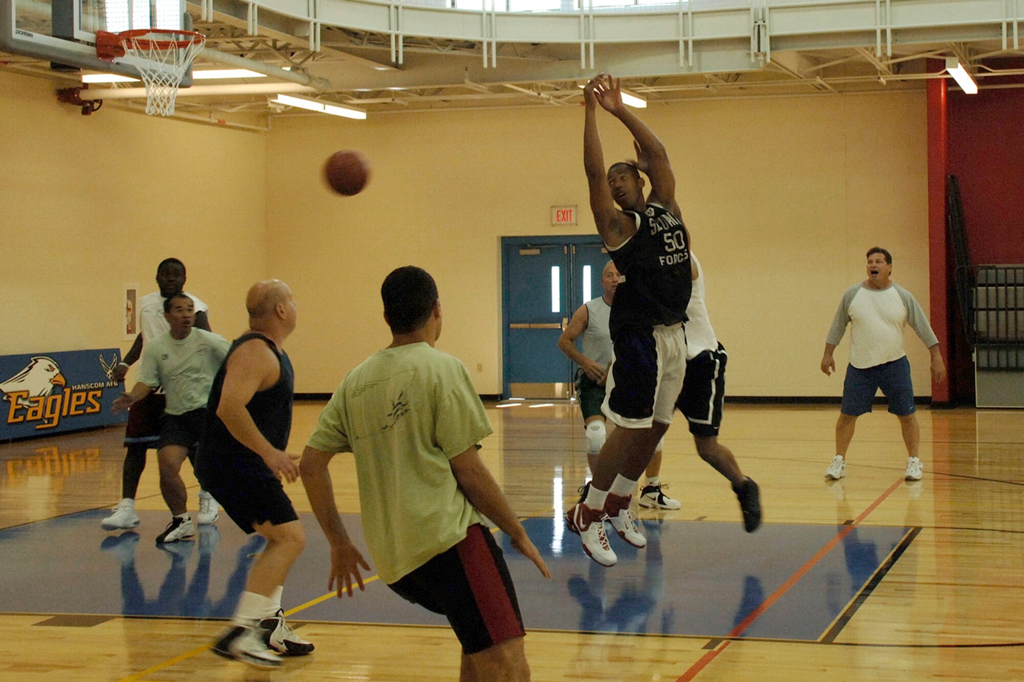 HANSCOM AFB, Mass. -- Members of the Hanscom community use the new fitness center’s basketball court for the first time Sept. 5. In order to play basketball, patrons must obey the fitness center’s no black soles or street shoes policy.

The new fitness center is equipped with three racquetball courts, an indoor running track and an NCAA-sized basketball court. The facility also houses steam rooms, saunas, aerobics rooms, a family/child workout room, stretching areas, massage room,  and larger locker rooms. (Photo by Jan Abate)