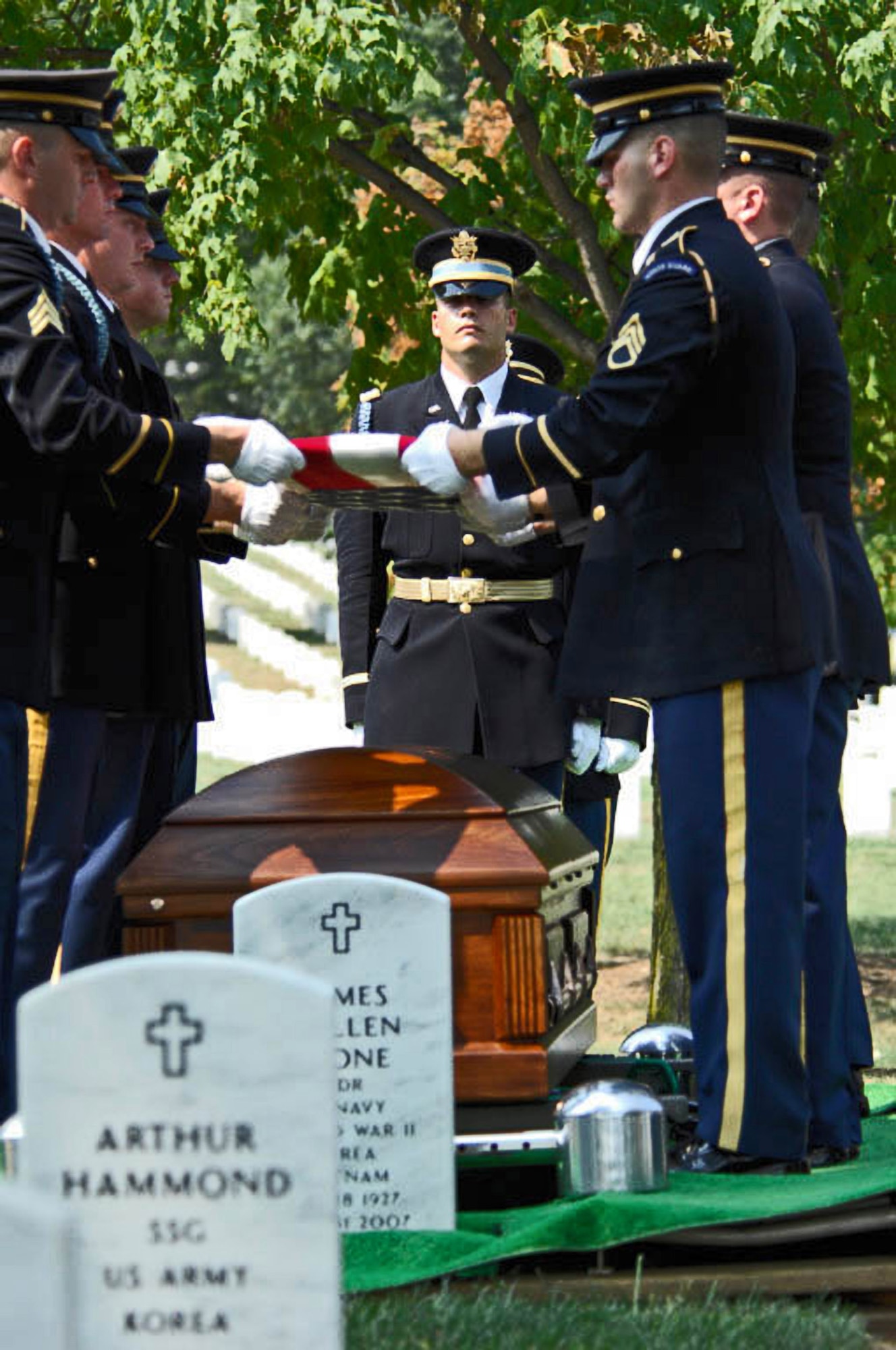 Army Color Guard members fold a flag from the casket of 2nd Lt. Harold E. Hoskin during a burial ceremony Sept. 7 at Arlington National Cemetery in Virginia. Lieutenant Hoskin was one of five men who were flying in a B-24 Liberator that crashed while on a test flight Dec. 21, 1943, out of Ladd Field in Fairbanks, Alaska. Lieutenant Hoskin's remains were discovered in August 2006 and identified in April 2007. (U.S. Air Force photo/Tech. Sgt. Cohen A. Young) 
