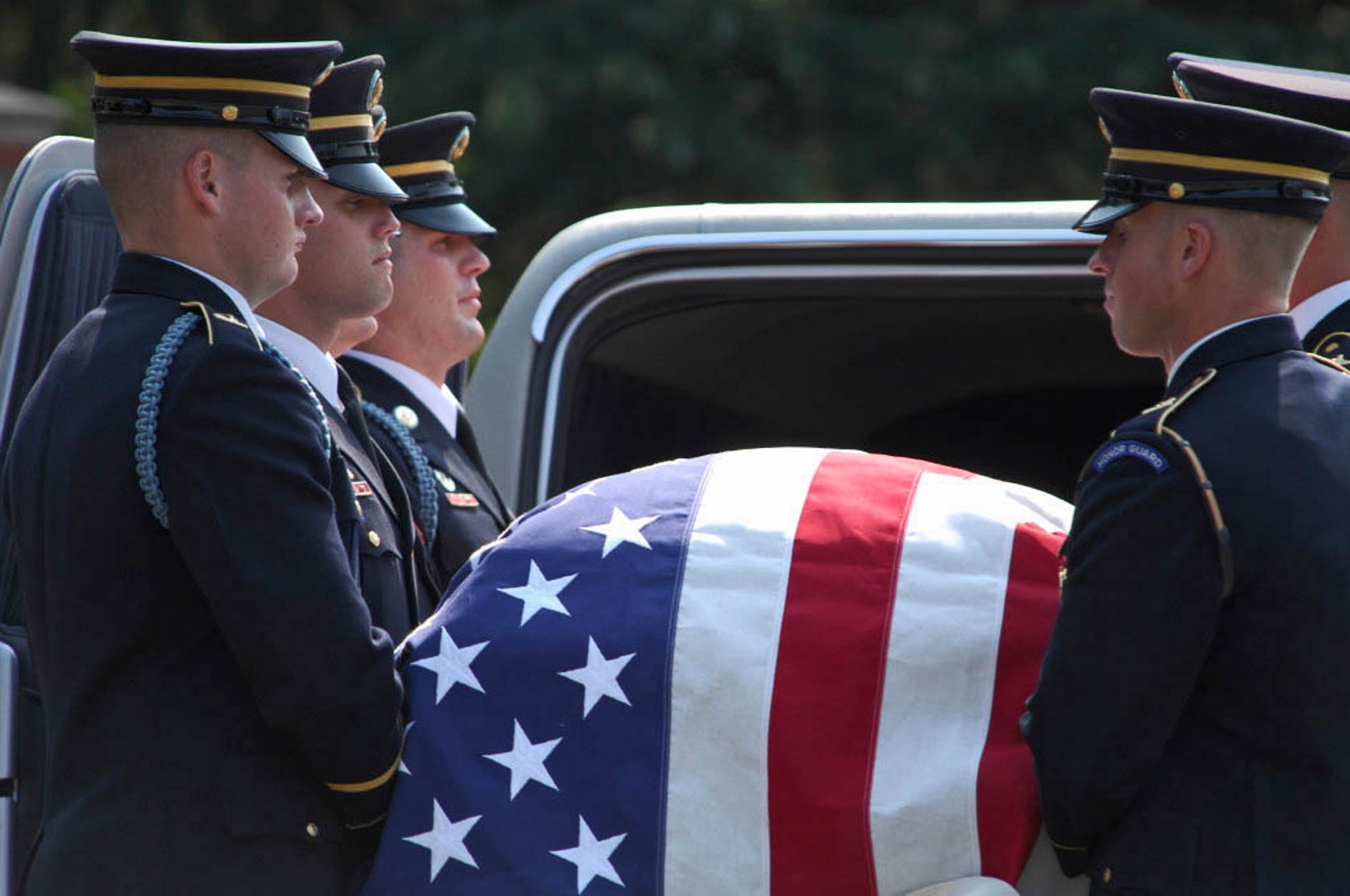 Army Color Guard members carry the casket of 2nd Lt. Harold E. Hoskin into the Fort Myer Old Post Chapel before the start of his funeral procession Sept. 7 at Arlington National Cemetery in Virginia. Lieutenant Hoskin was one of five men who were flying in a B-24 Liberator that crashed while on a test flight Dec. 21, 1943, out of Ladd Field in Fairbanks, Alaska. Lieutenant Hoskin's remains were discovered in August 2006 and identified in April 2007. (U.S. Air Force photo/Tech. Sgt. Cohen A. Young) 

