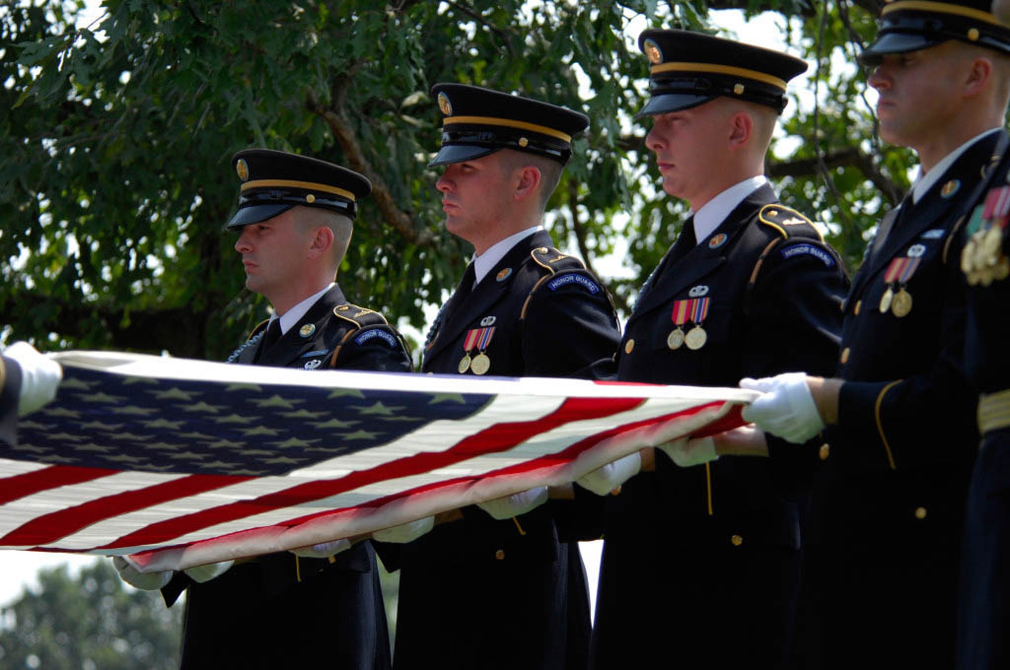 Army Color Guard members fold a flag from the casket of 2nd Lt. Harold Elton Hoskin during a burial ceremony Sept. 7 at Arlington National Cemetery in Virginia. Lieutenant Hoskin was one of five men who were flying in a B-24 Liberator that crashed while on a test flight Dec. 21, 1943, out of Ladd Field in Fairbanks, Alaska. Lieutenant Hoskin's remains were discovered in August 2006 and identified in April 2007. (U.S. Air Force photo/Tech. Sgt. Cohen A. Young) 
